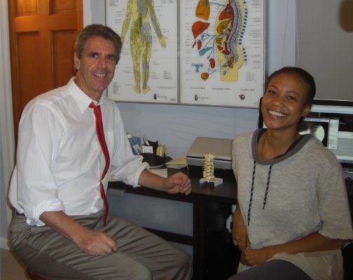 Dr. Feier with a patient at his desk