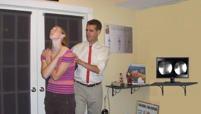Dr. Feier checking a patient's posture